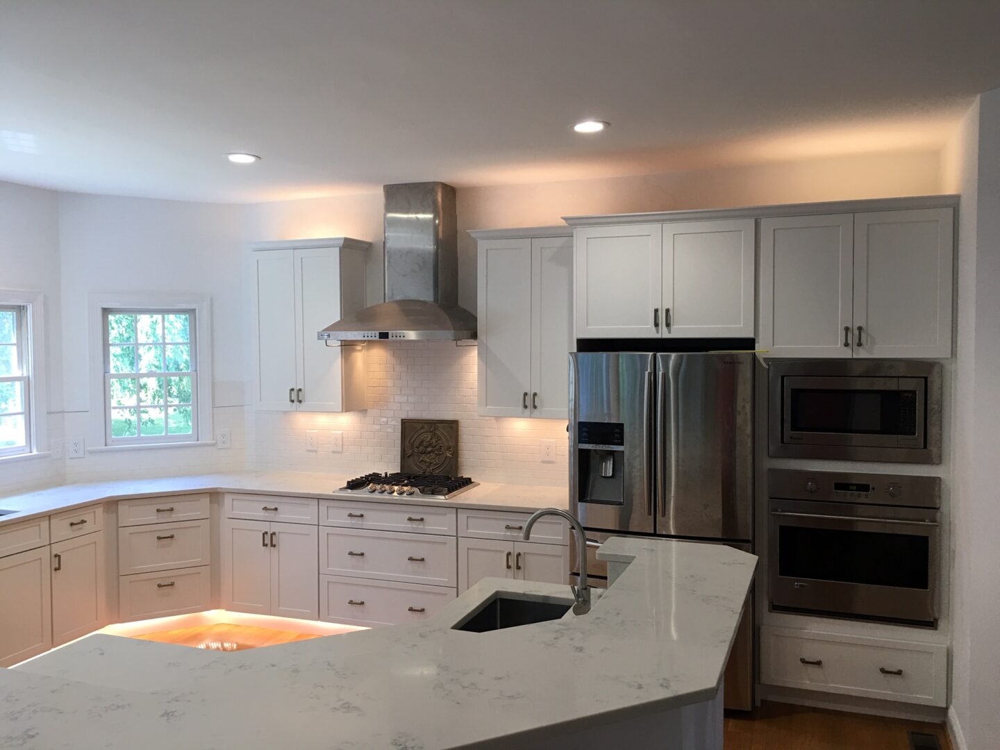 A kitchen with white cabinets and stainless steel appliances.