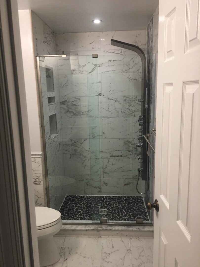 A bathroom with a walk in shower and toilet.