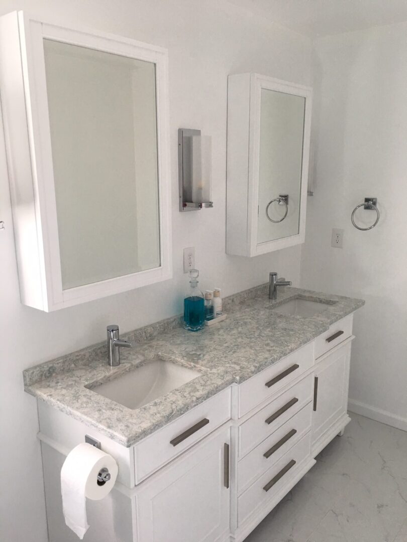 A bathroom with two sinks and mirrors.