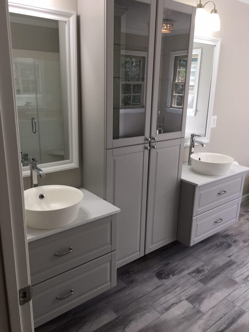 A bathroom with two sinks and a mirror.