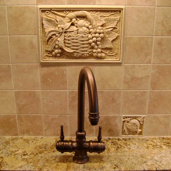 A sink with a faucet and tile backsplash