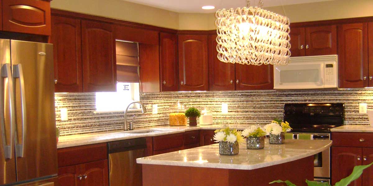 A kitchen with wooden cabinets and white counter tops.