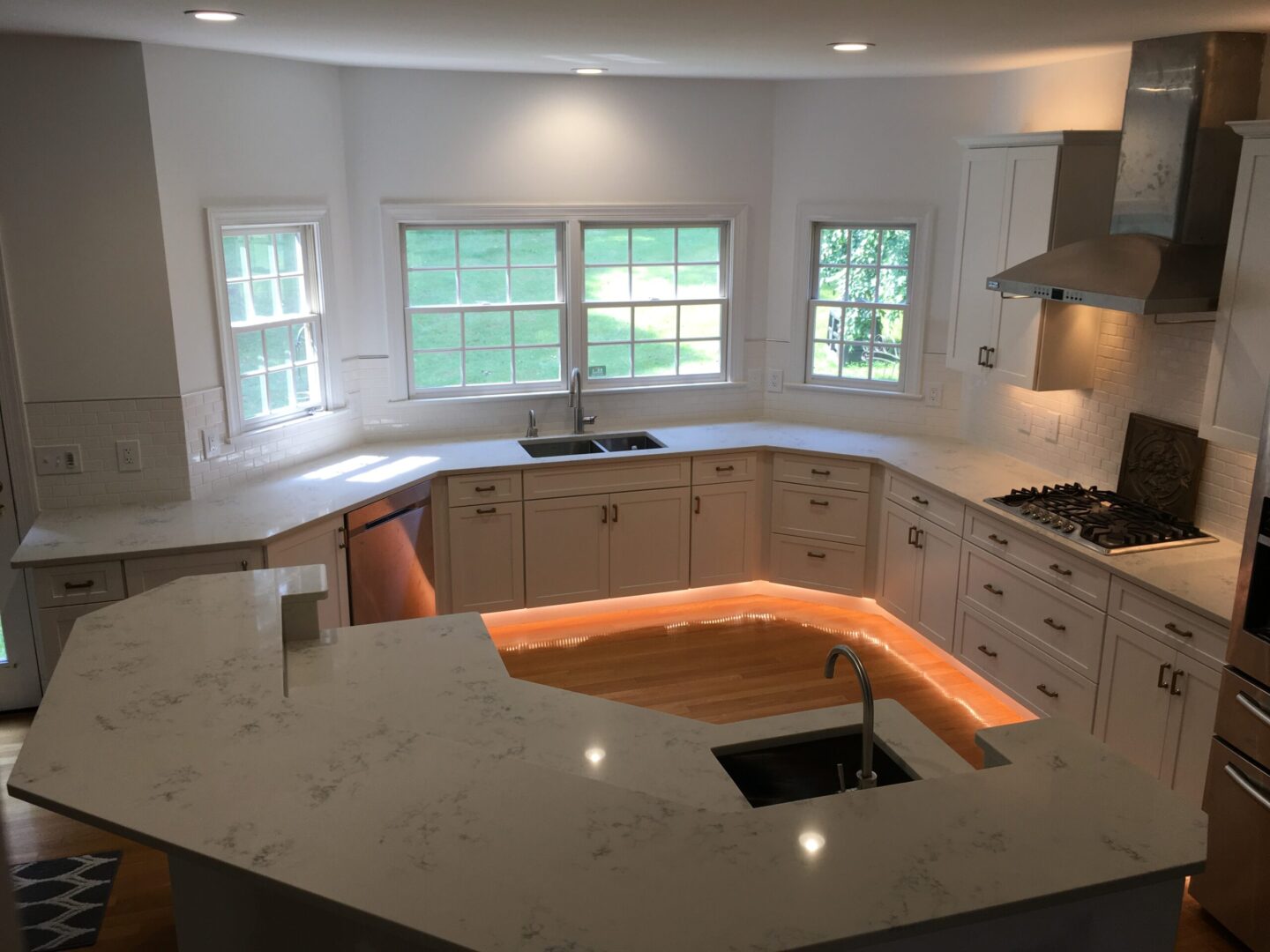 A kitchen with an island and sink in it