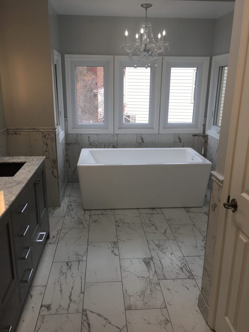 A bathroom with marble floors and walls.